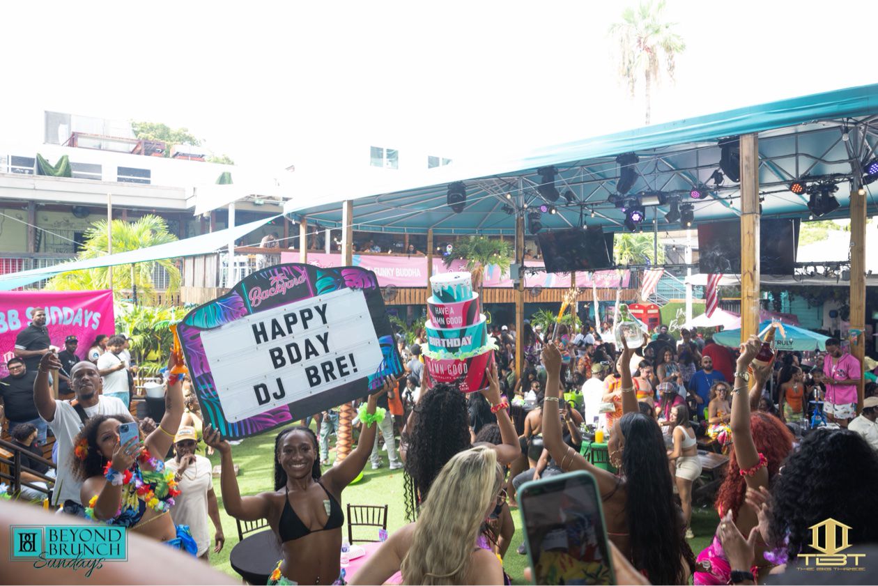 Brunch guests with a Happy Birthday DJ BRE sign