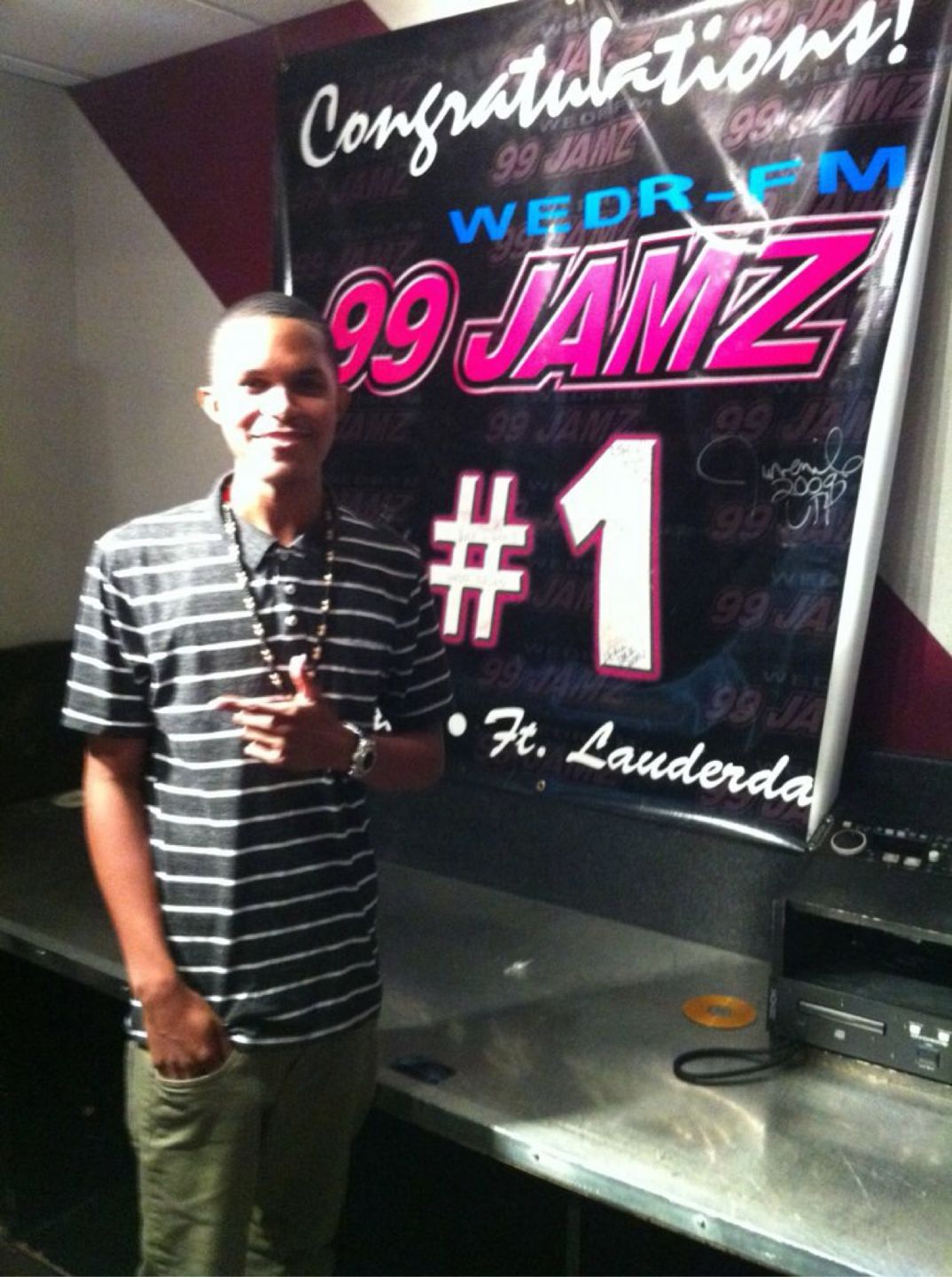 DJ BRE by a 99 JAMZ radio milestone display