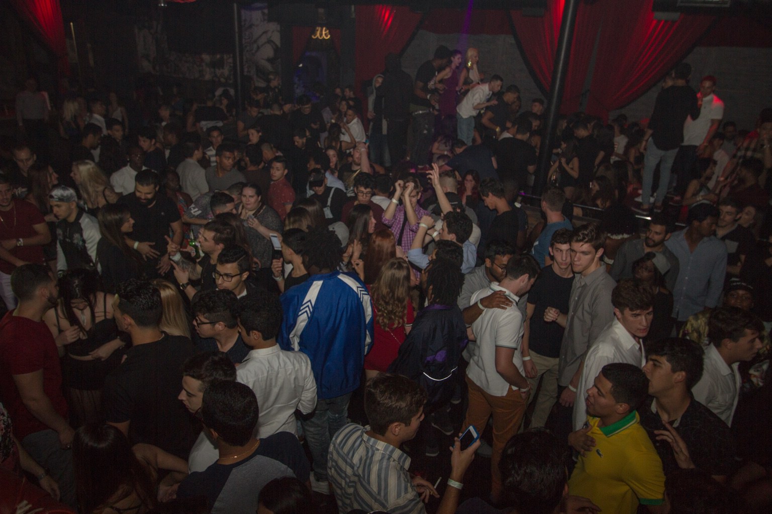 A packed nightclub dance floor at a DJ event